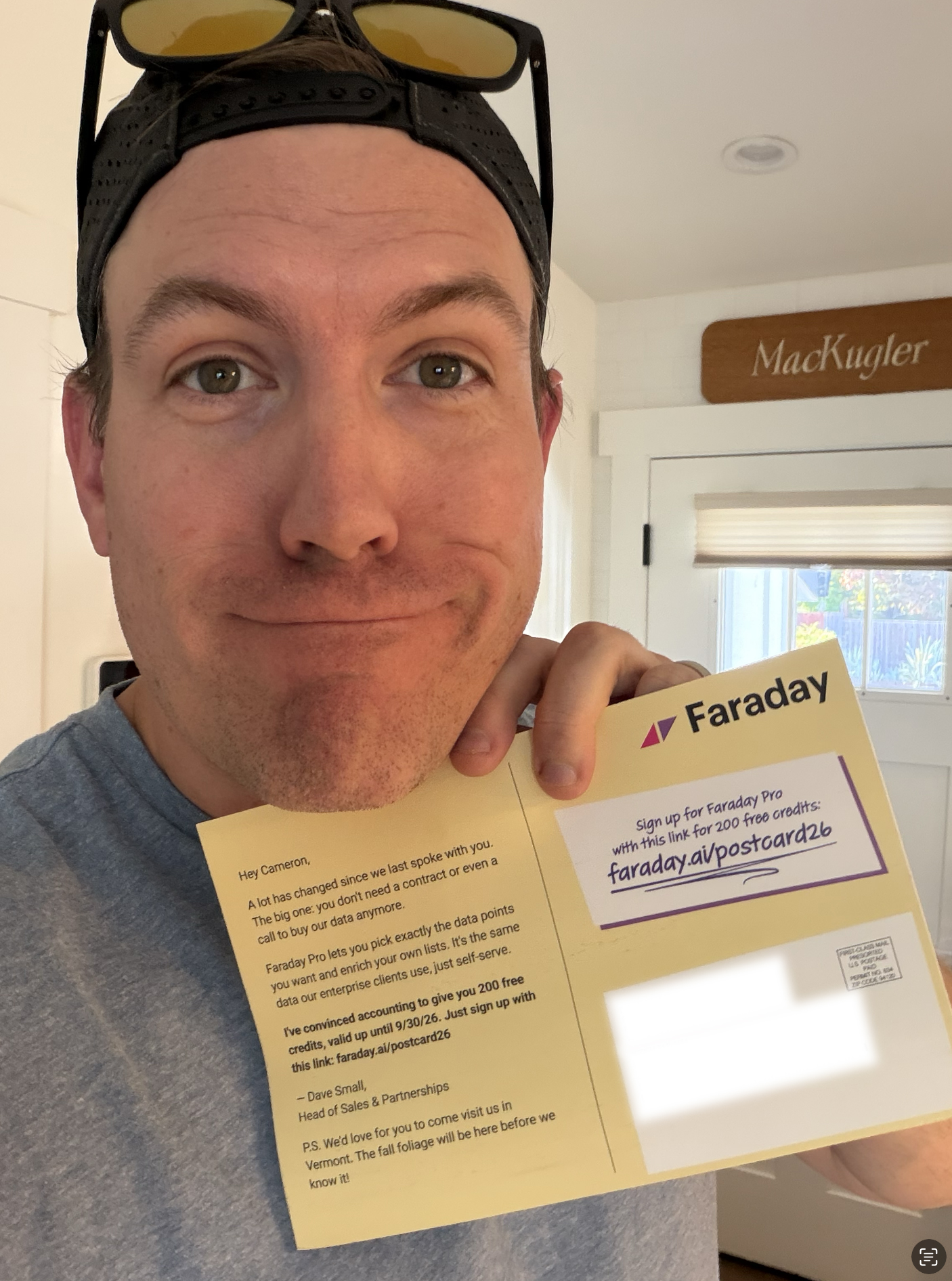 Happy customer posing with their recently recieved Faraday postcard
